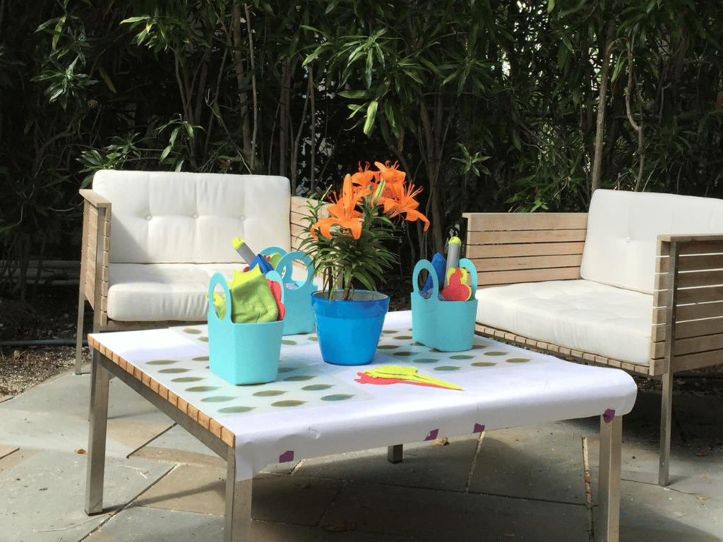 Gabrielle bags propped up on wooden table with flowers.